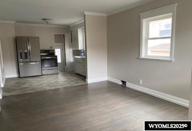 kitchen with gray cabinetry, ornamental molding, baseboards, and stainless steel appliances