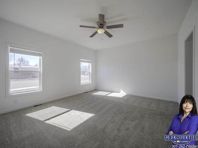 spare room with visible vents, baseboards, ceiling fan, and carpet flooring