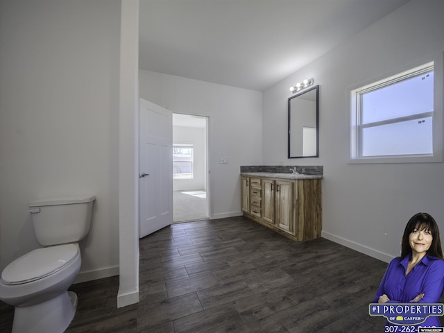 bathroom featuring vanity, baseboards, and wood finished floors