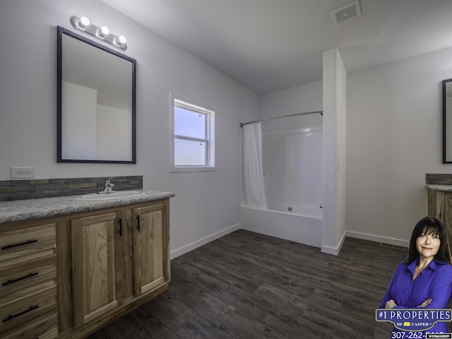 full bath with shower / tub combo with curtain, visible vents, vanity, wood finished floors, and baseboards