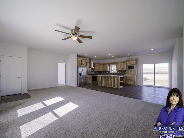 unfurnished living room featuring a ceiling fan, recessed lighting, and dark carpet