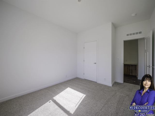 unfurnished bedroom with visible vents, baseboards, and carpet flooring