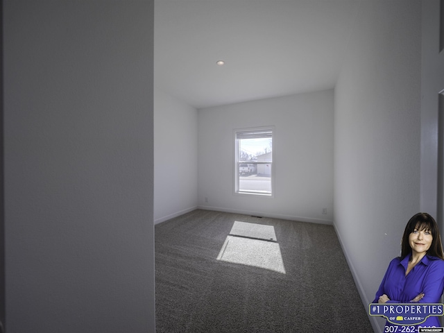 unfurnished room featuring carpet floors and baseboards