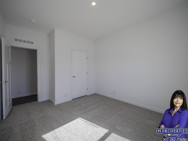 unfurnished bedroom featuring recessed lighting, carpet flooring, visible vents, and baseboards