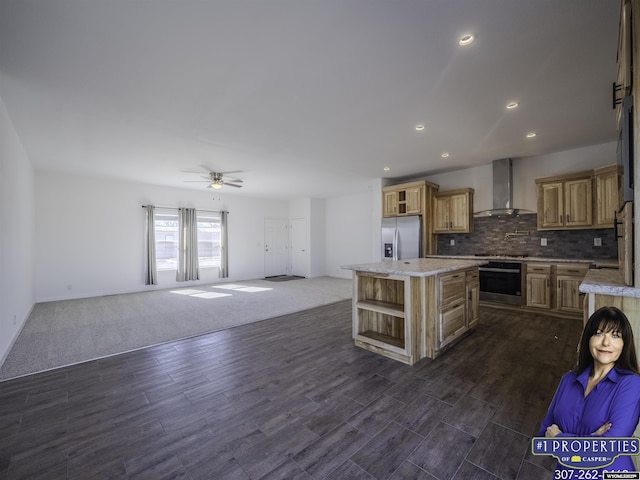 kitchen featuring stainless steel appliances, open floor plan, wall chimney exhaust hood, and open shelves