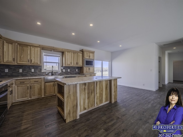 kitchen with decorative backsplash, dark wood-style floors, a kitchen island, built in microwave, and a sink