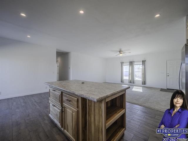 kitchen with a kitchen island, open shelves, a ceiling fan, and open floor plan