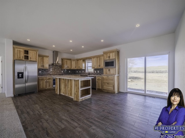 kitchen featuring stainless steel appliances, open shelves, backsplash, a wealth of natural light, and wall chimney exhaust hood