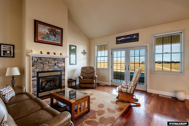 interior space featuring french doors, hardwood / wood-style floors, a fireplace, and baseboards