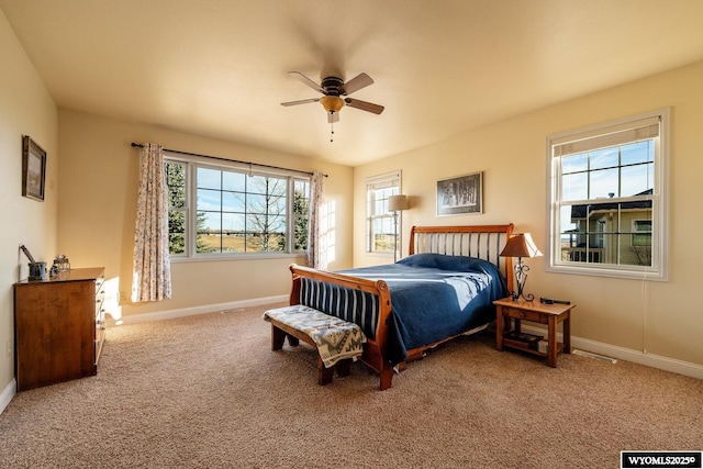 bedroom with carpet floors, ceiling fan, and baseboards