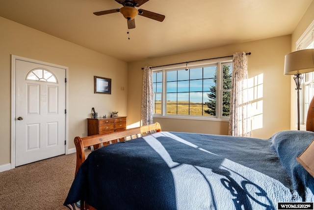 carpeted bedroom featuring a ceiling fan and baseboards