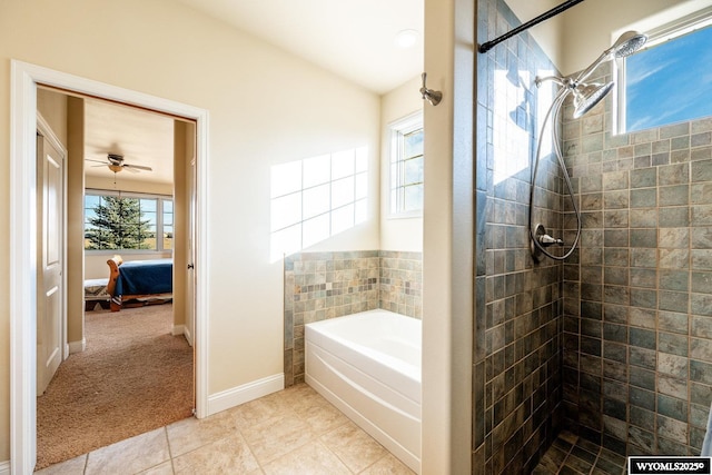 ensuite bathroom featuring connected bathroom, a tile shower, a bath, baseboards, and tile patterned floors