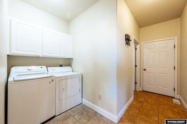 washroom with cabinet space, light tile patterned floors, baseboards, and washer and dryer