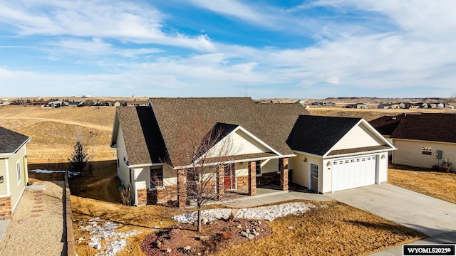 view of front of home with stone siding, concrete driveway, covered porch, and an attached garage