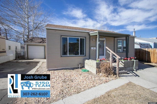 view of front of property with a garage, concrete driveway, covered porch, and fence