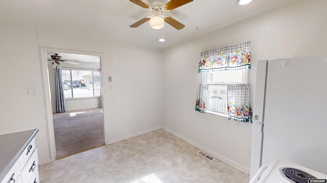 kitchen with visible vents, baseboards, freestanding refrigerator, and recessed lighting