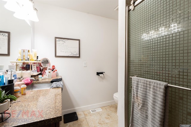 bathroom featuring baseboards, toilet, tile patterned flooring, vanity, and a shower stall