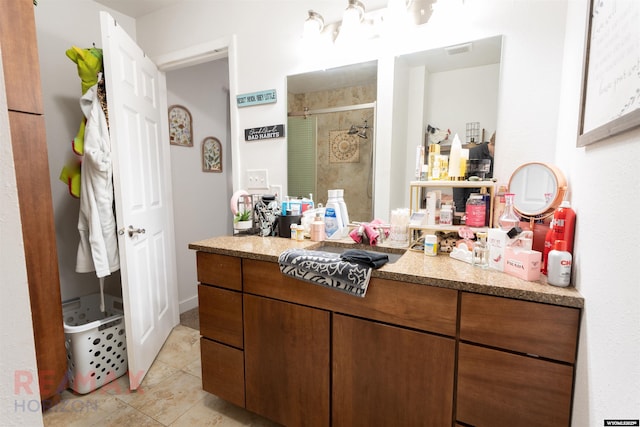 bathroom with a stall shower, tile patterned flooring, visible vents, and vanity