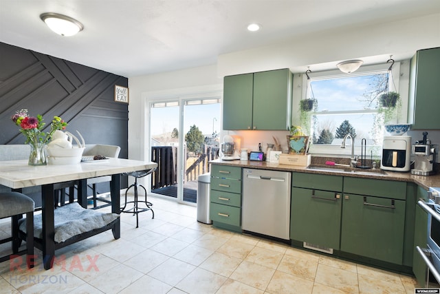 kitchen with a sink, green cabinets, dishwasher, and light tile patterned flooring