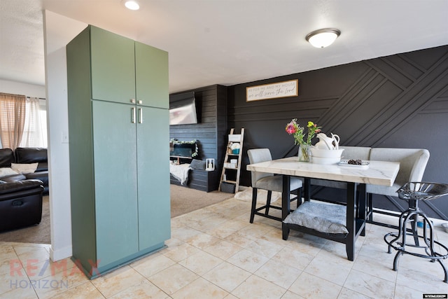 dining area featuring light tile patterned floors and light colored carpet