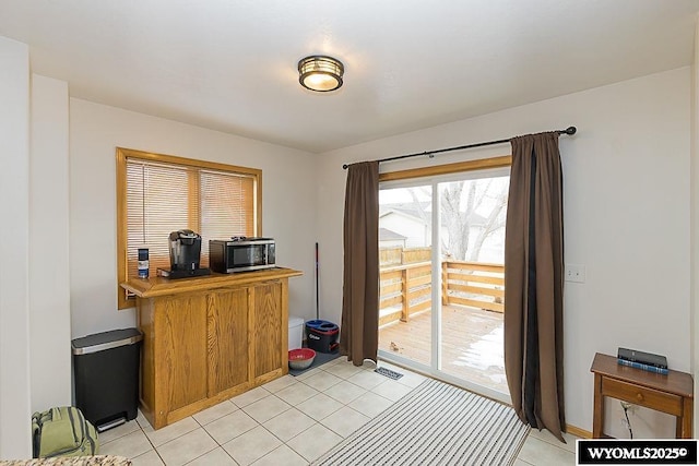 home office with light tile patterned floors and visible vents