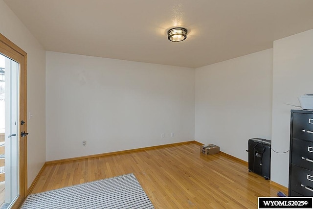 empty room with light wood-style floors and baseboards