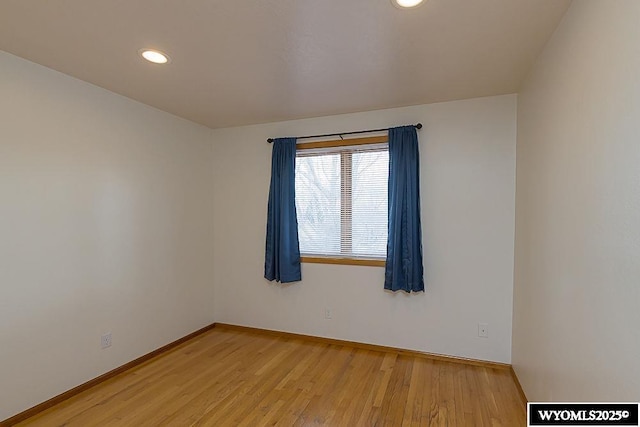 spare room with light wood finished floors, recessed lighting, and baseboards