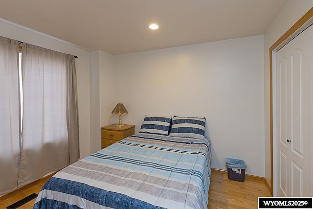 bedroom with recessed lighting and wood finished floors