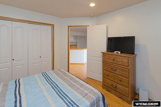 bedroom featuring recessed lighting, a closet, and light wood finished floors