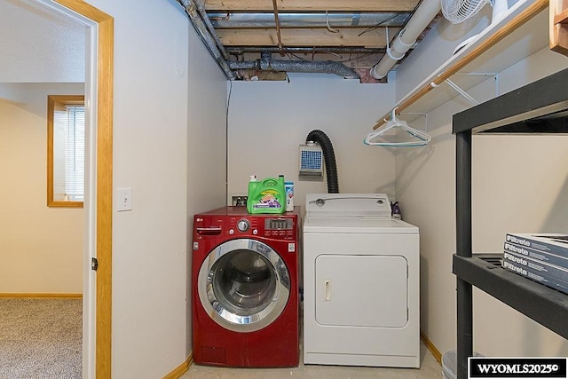 clothes washing area featuring independent washer and dryer and baseboards