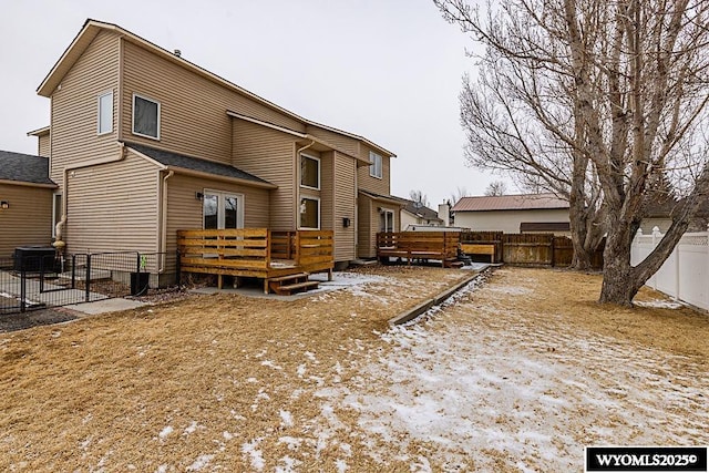 back of house featuring a deck and a fenced backyard