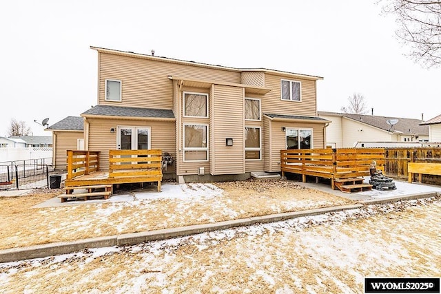 back of house featuring fence and a wooden deck