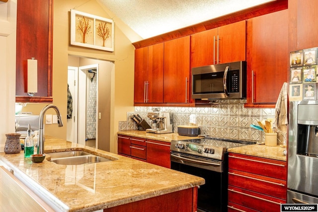 kitchen featuring lofted ceiling, backsplash, stainless steel appliances, and a sink