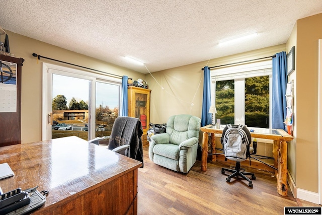 home office featuring a textured ceiling and wood finished floors