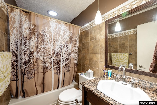 bathroom featuring a textured ceiling, toilet, vanity, tile walls, and shower / bath combo