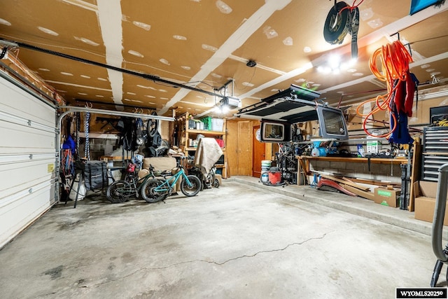 garage with a workshop area and a garage door opener