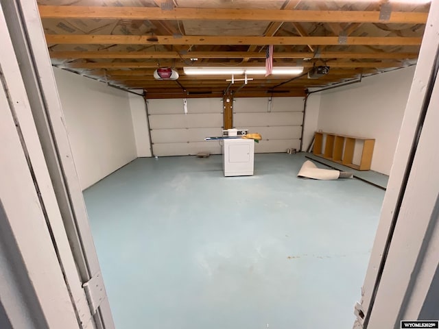 garage featuring washer / dryer and a garage door opener