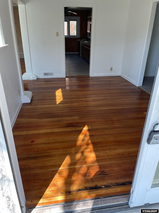 interior space featuring wood finished floors, visible vents, and baseboards