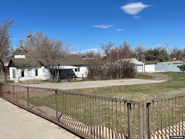 view of yard with a fenced front yard and a garage