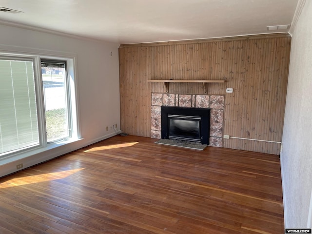 unfurnished living room featuring wood-type flooring, a fireplace, and visible vents