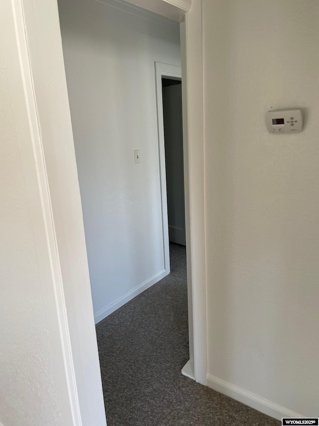 corridor with carpet flooring and baseboards