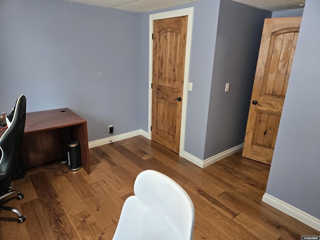 home office featuring baseboards and wood finished floors