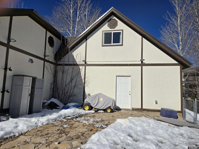 exterior space featuring fence and stucco siding