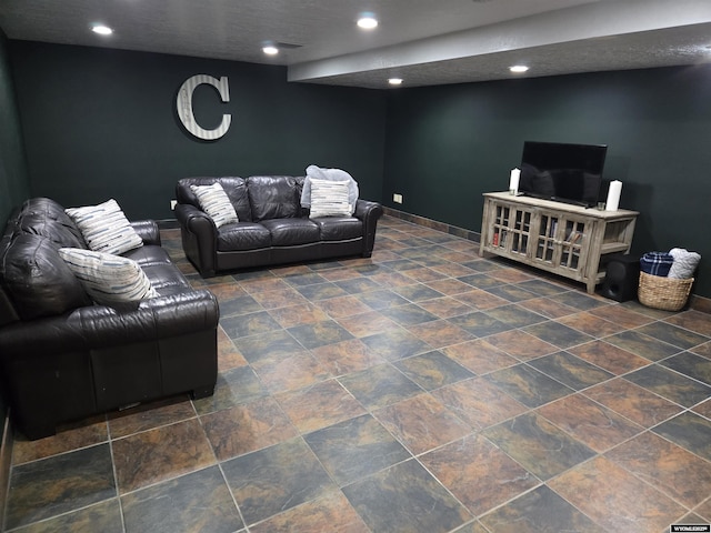 living room with recessed lighting, stone finish floor, and baseboards