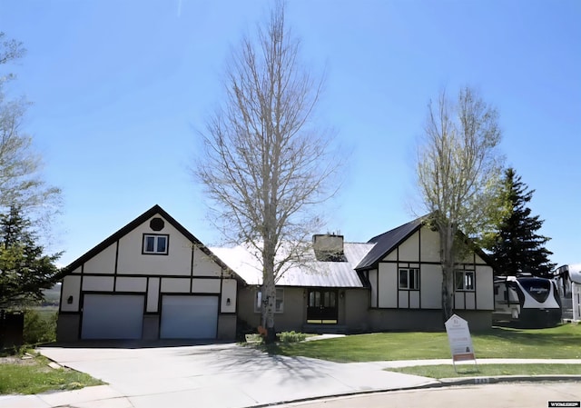 249 Aspen Hls, Evanston, WY 82930 - tudor home with stucco siding, a front yard, driveway, and a garage