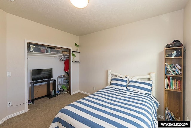 carpeted bedroom featuring a textured ceiling and baseboards