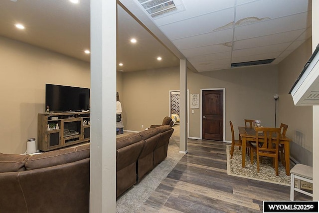 living room with wood finished floors, visible vents, and recessed lighting