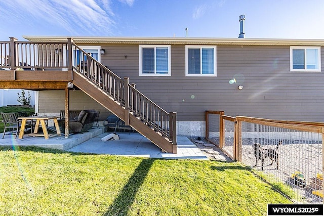 back of property featuring a patio area, a lawn, fence, and stairs