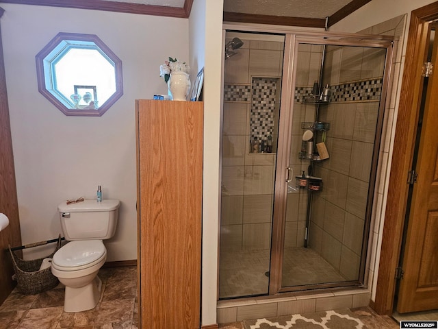 bathroom featuring ornamental molding, a stall shower, baseboards, and toilet