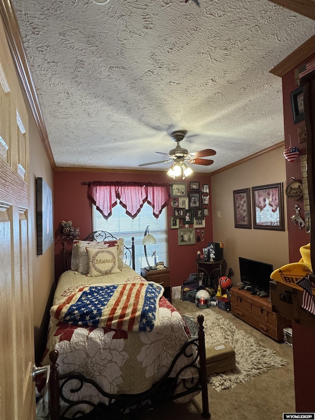 carpeted bedroom with a textured ceiling, ornamental molding, and a ceiling fan